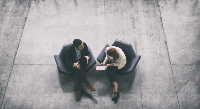 Overhead View Of Two Business Persons In The Lobby